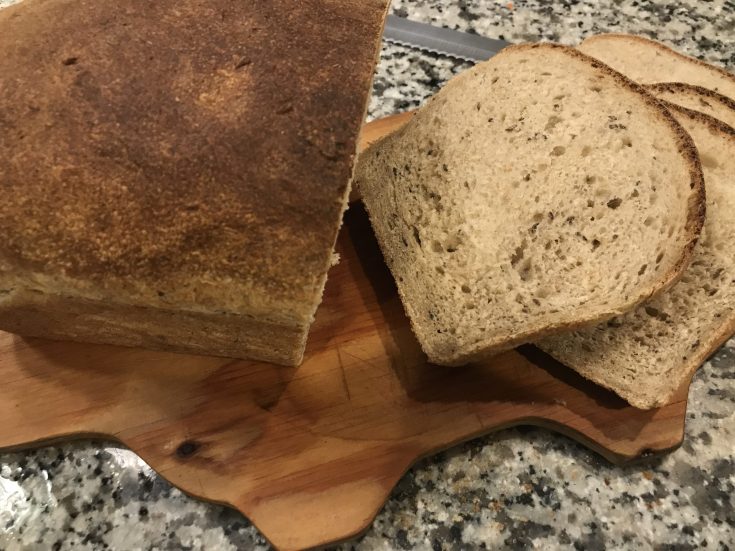 sliced sourdough rye bread on wooden cutting board
