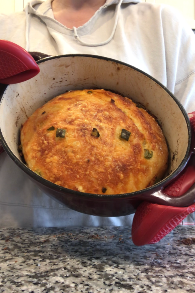 dutch oven filled with jalapeño cheddar sourdough bread 